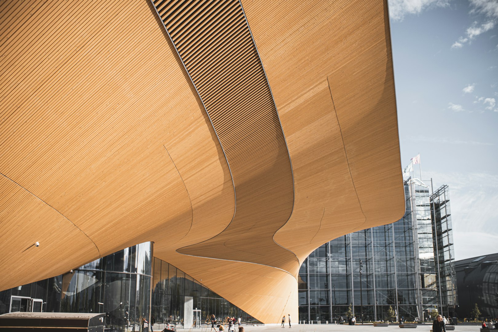 This image shows the exterior of the Helsinki Central Library Oodi in Finland, a modern architectural landmark