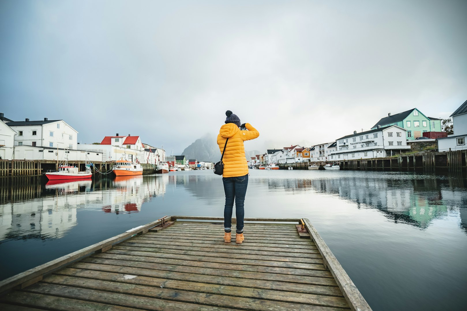 Woman taking photograph from dockside