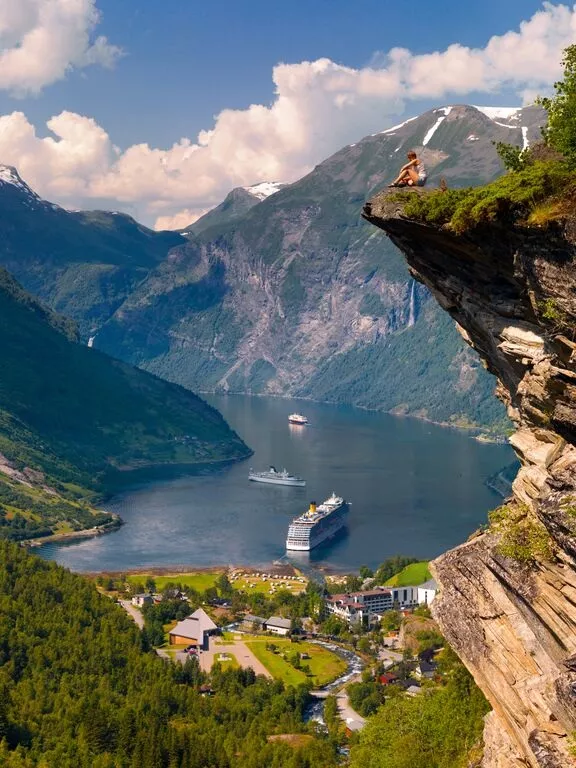 girl overlooking fjords and cruise ships below