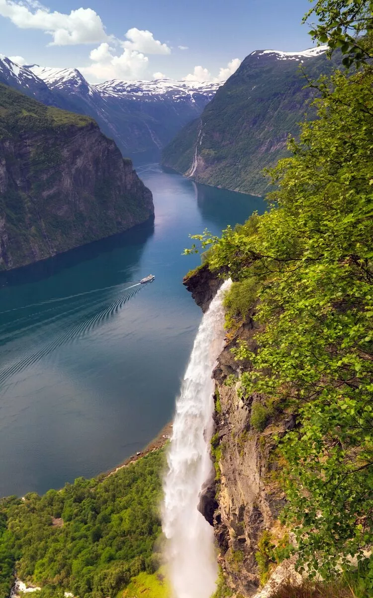 view of fjord from on high with cruise ship travelling through